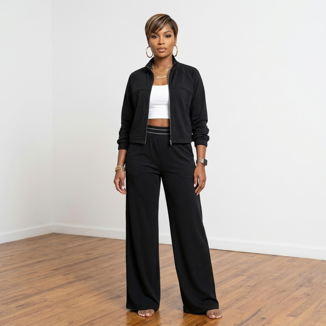 Front view of the Erica Track Suit in black with a zippered jacket, side pockets and matching elastic-waist pants.