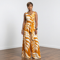 Dion deep mustard leaf print V-neck loose fit jumpsuit worn by model – House of Charlotte Boutique