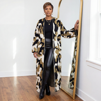 Jessie oversized maxi length camo cardigan worn open over a black tee and black leather leggings, styled with black stiletto boots