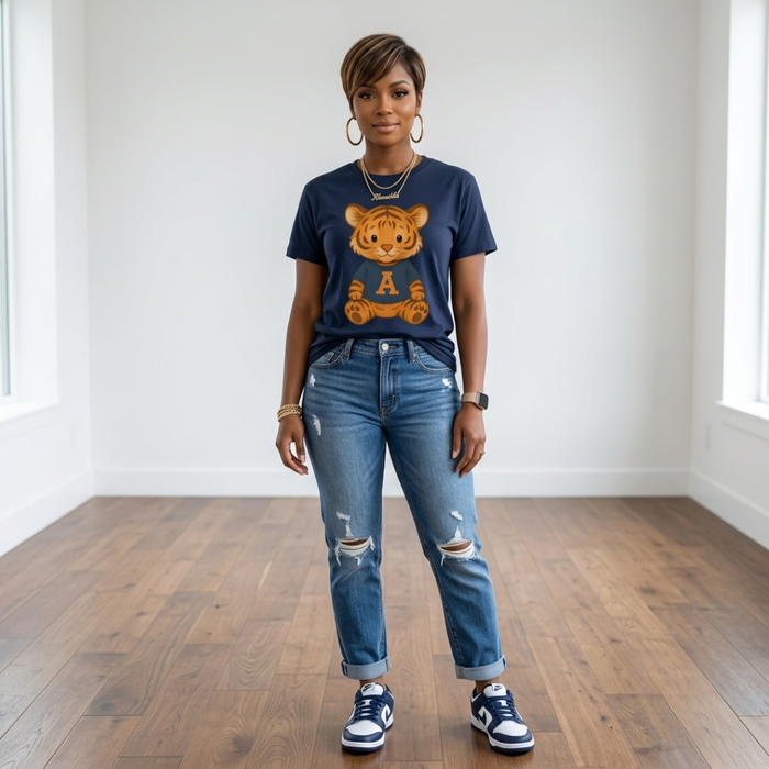 African American woman wearing the Tiger Game Day Tee in navy with cuffed distressed jeans and navy and white sneakers