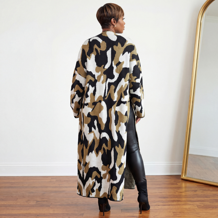Back view of the Jessie oversized maxi length camo cardigan showing full length drape just above the floor with black stiletto boots
