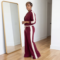 Side view of Klara woven burgundy and cream two-piece set with flared pants and stretch fabric