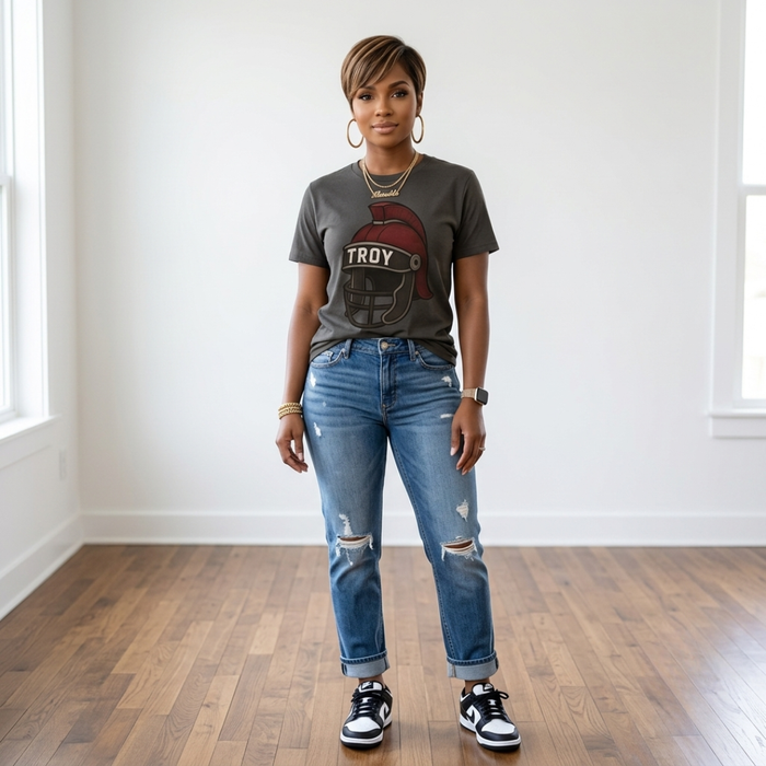 African American woman wearing the Trojan Game Day Tee in charcoal with cuffed distressed jeans and black and white sneakers