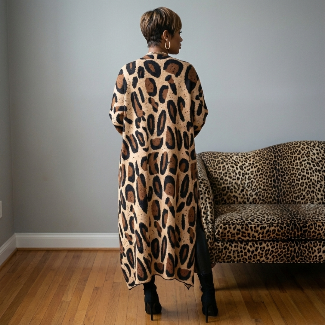 Person wearing a leopard print dress standing in a room with a matching leopard print sofa.