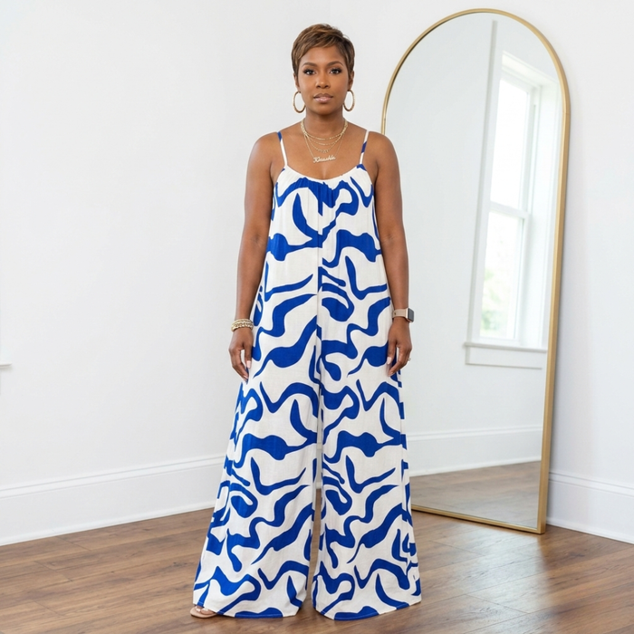 Blue and white spaghetti strap oversized wide leg jumpsuit with pockets and flowy silhouette on 5’3” model.
