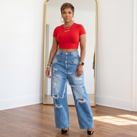 Model wearing Estelle distressed double layer wide leg jeans with red cropped tee and black heels