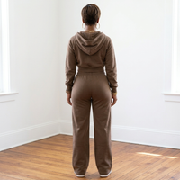 Back view of the fossil Tana Hooded Track Suit, showing the hood resting on the upper back and pants falling over the heels.