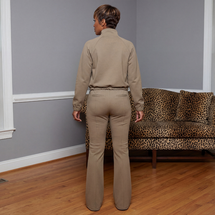Back view of the Lacey Knit Track Suit in heather gray showing the zip-front jacket with drawstring hem and flared knit pants with elastic waistband, back pockets, and a 33-inch inseam.