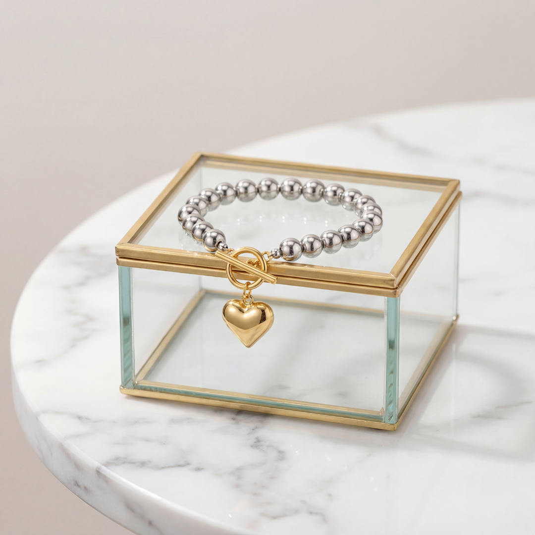 Mixed metal heart charm beaded bracelet featuring stainless steel and gold plated copper beads