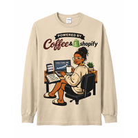 Beige long-sleeve shirt with a graphic of a woman at a desk and 'Powered by Coffee & Shopify' text.
