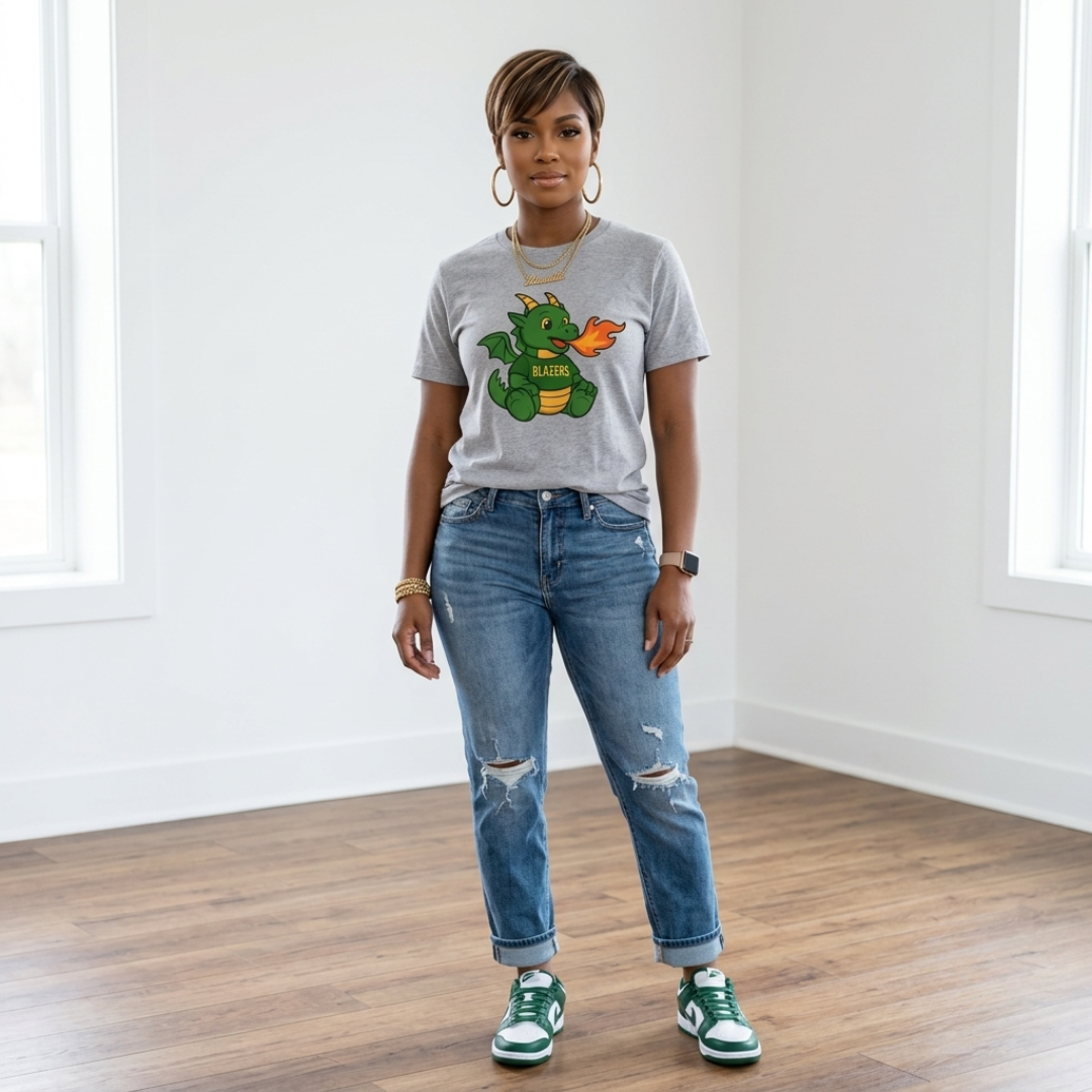 African American woman wearing the Blazers Game Day Tee in gray with cuffed distressed jeans and green and white sneakers.
