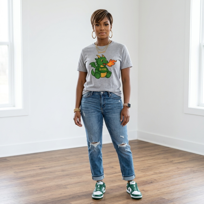 African American woman wearing the Blazers Game Day Tee in gray with cuffed distressed jeans and green and white sneakers.