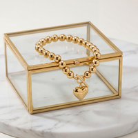 Close-up of heart charm beaded bracelet highlighting 35mm heart pendant and polished bead design