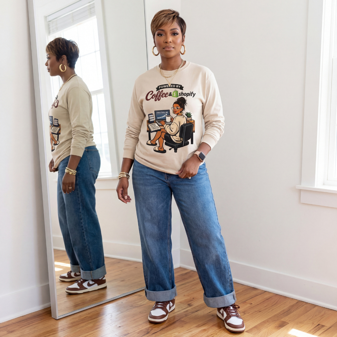 Woman wearing Powered by Coffee & Shopify long sleeve graphic tee styled with denim and sneakers