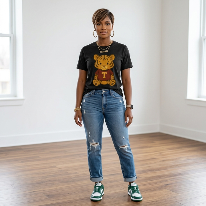 African American woman wearing the Golden Tiger Game Day Tee in black heather with cuffed distressed jeans and black and white sneakers.